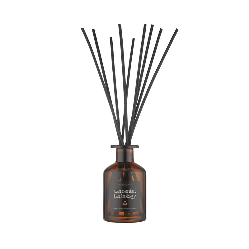 Room fragrance reed diffuser with scents of sweet orange, bergamot, and neroli.